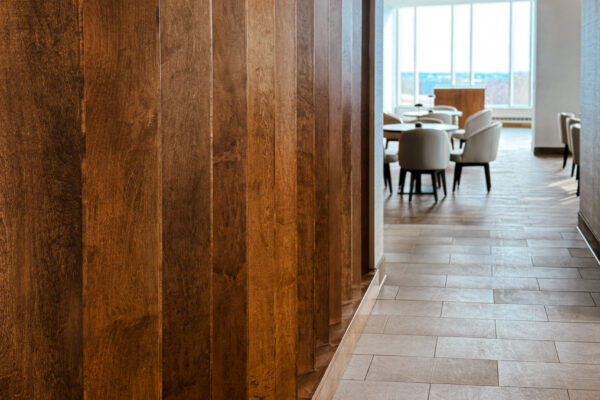 Close up detail image of the wood wall details looking toward eating area at the Highpoint Hotel in Sioux Falls